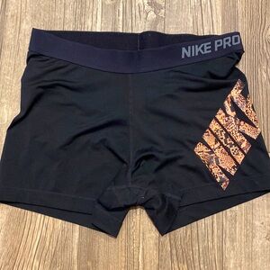 Nike pro, dri-fit shorts, black with neon coral design. Size XL.